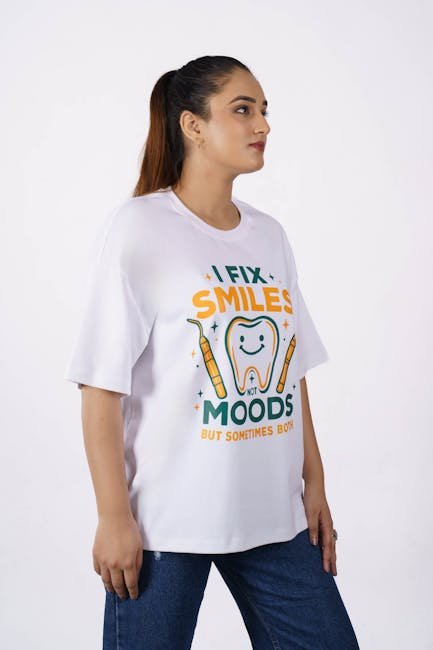 Portrait of a woman in an oversized T-shirt featuring a dental humor design, photographed indoors.